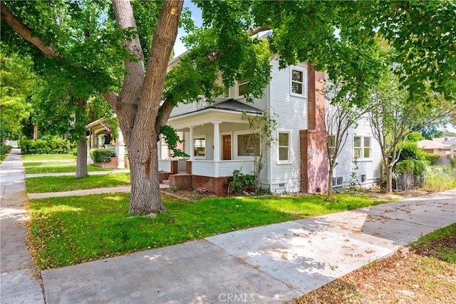 4415 12th St, Riverside, CA 92501 - american foursquare style home featuring a porch and a front lawn