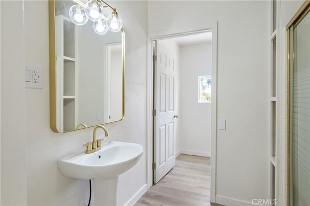 4415 12th St, Riverside, CA 92501 - bathroom featuring wood finished floors, an enclosed shower, and baseboards