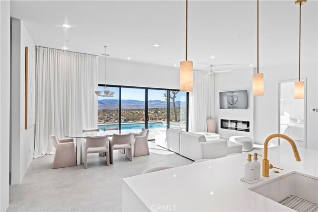 59425 Sun Mesa Rd, Yucca Valley, CA 92284 - kitchen featuring a sink, open floor plan, recessed lighting, concrete floors, and hanging light fixtures