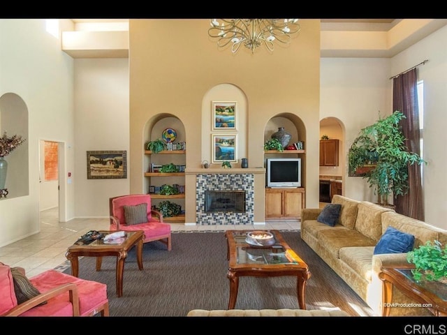 1875 Baudouin Pl Unit 1731, Chula Vista, CA 91913 - tiled living area featuring built in shelves, a high ceiling, a chandelier, a fireplace, and arched walkways
