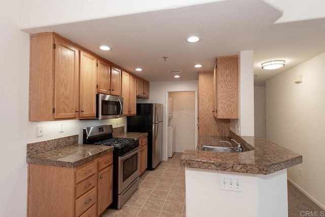 1875 Baudouin Pl Unit 1731, Chula Vista, CA 91913 - kitchen with appliances with stainless steel finishes, a peninsula, a sink, baseboards, and tile counters