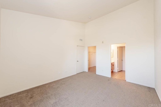 1875 Baudouin Pl Unit 1731, Chula Vista, CA 91913 - unfurnished bedroom with light colored carpet, a spacious closet, a high ceiling, a closet, and baseboards
