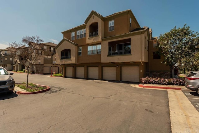 1875 Baudouin Pl Unit 1731, Chula Vista, CA 91913 - view of front of home featuring stucco siding, a garage, and a residential view