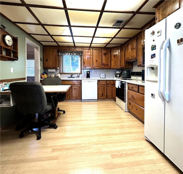 950 Cedar St, Corona, CA 92879 - kitchen with white appliances, light countertops, light wood-style flooring, and a sink