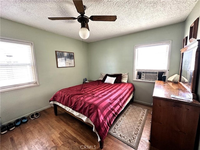 950 Cedar St, Corona, CA 92879 - bedroom featuring wood finished floors, cooling unit, a textured ceiling, baseboards, and a ceiling fan