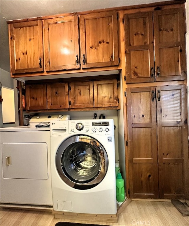 950 Cedar St, Corona, CA 92879 - laundry area with cabinet space, washer and dryer, and light wood-style flooring