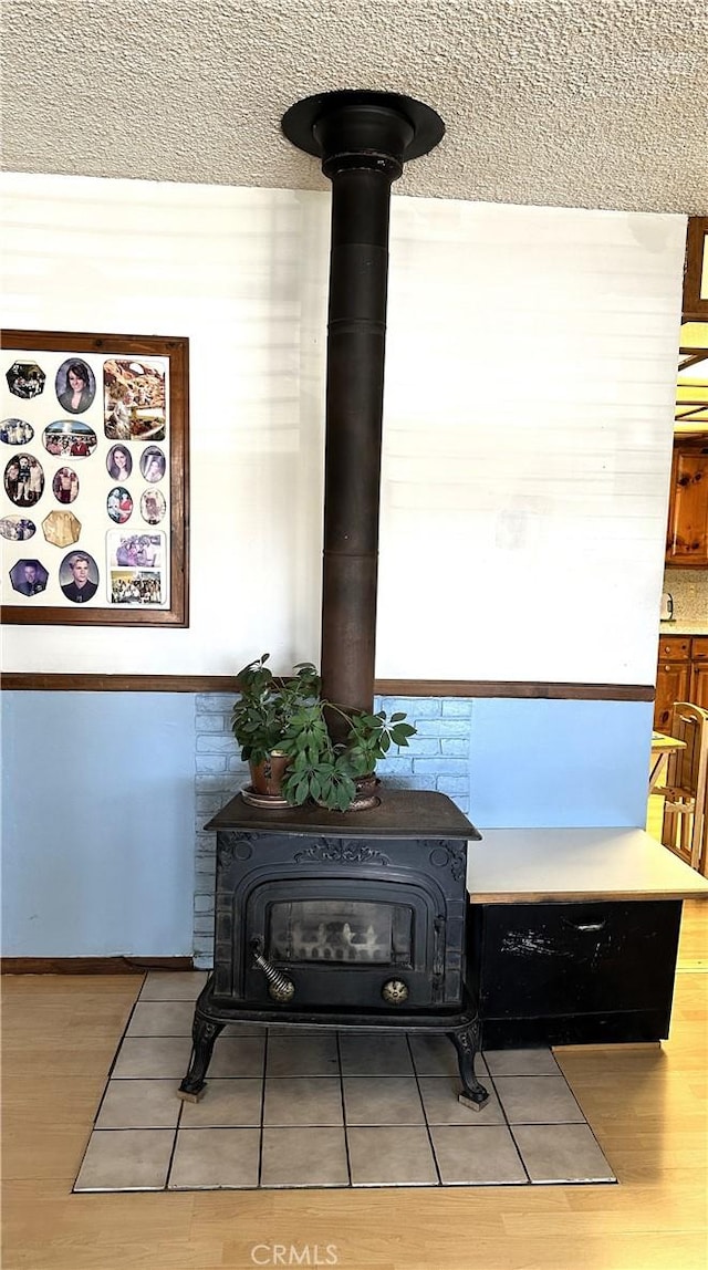 950 Cedar St, Corona, CA 92879 - detailed view of a wood stove, wood finished floors, and a textured ceiling