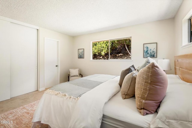 815 Perry Ave, Montebello, CA 90640 - carpeted bedroom featuring a closet and a textured ceiling