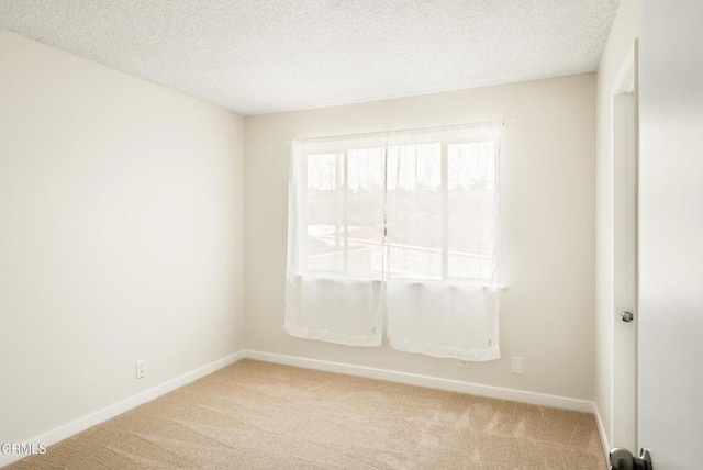 815 Perry Ave, Montebello, CA 90640 - empty room with light colored carpet, baseboards, and a textured ceiling