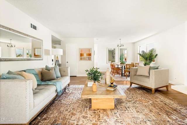 815 Perry Ave, Montebello, CA 90640 - living area with a chandelier, wood finished floors, and baseboards