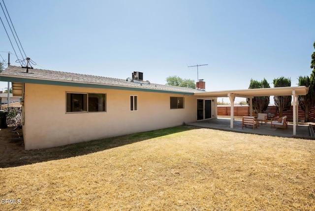 815 Perry Ave, Montebello, CA 90640 - rear view of property featuring stucco siding, a patio area, and a chimney