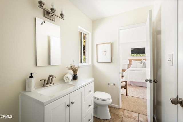 815 Perry Ave, Montebello, CA 90640 - bathroom with vanity, toilet, ensuite bath, baseboards, and tile patterned floors