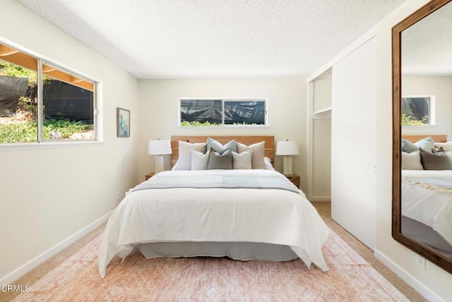 815 Perry Ave, Montebello, CA 90640 - bedroom with a textured ceiling, light carpet, and baseboards