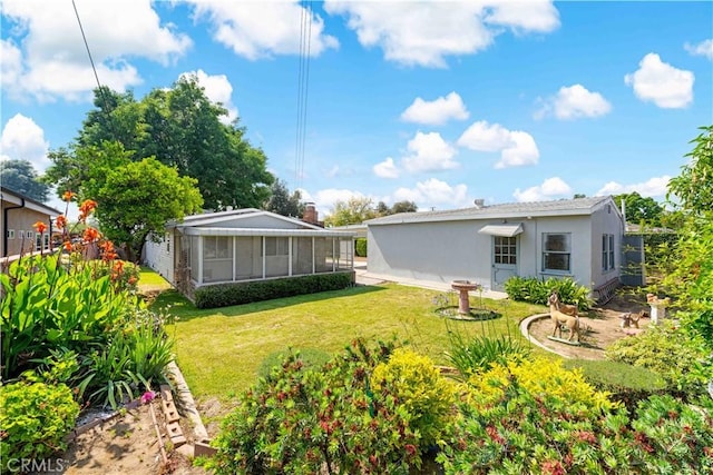 430 N Ellen Dr, West Covina, CA 91790 - back of house with stucco siding, a yard, and a sunroom