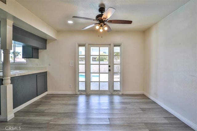 11112 Camellia Ave, Fountain Valley, CA 92708 - unfurnished dining area with a ceiling fan, plenty of natural light, wood finished floors, and baseboards