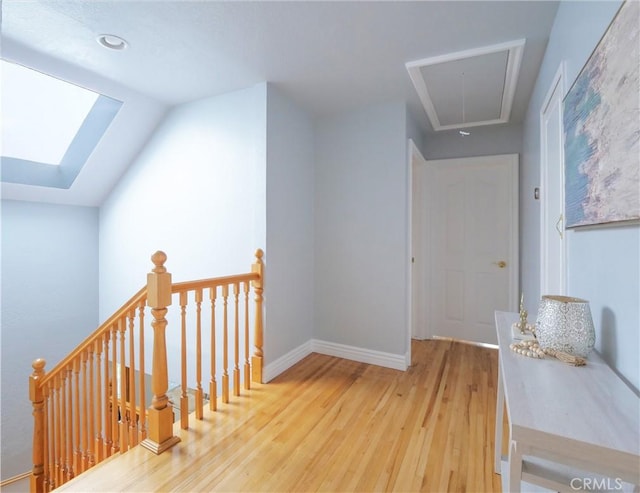 1163 Sandwood Pl, San Pedro, CA 90731 - hallway featuring attic access, an upstairs landing, wood finished floors, a skylight, and baseboards