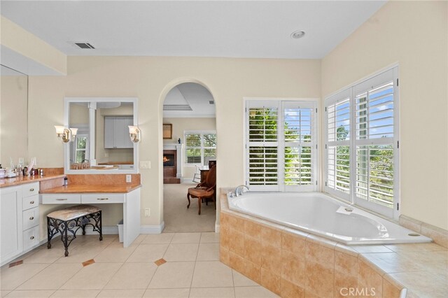 43845 Calle De Velardo, Temecula, CA 92592 - full bath with a garden tub, a lit fireplace, vanity, and tile patterned floors