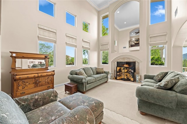 43845 Calle De Velardo, Temecula, CA 92592 - living area with ornamental molding, a towering ceiling, a high end fireplace, arched walkways, and carpet floors