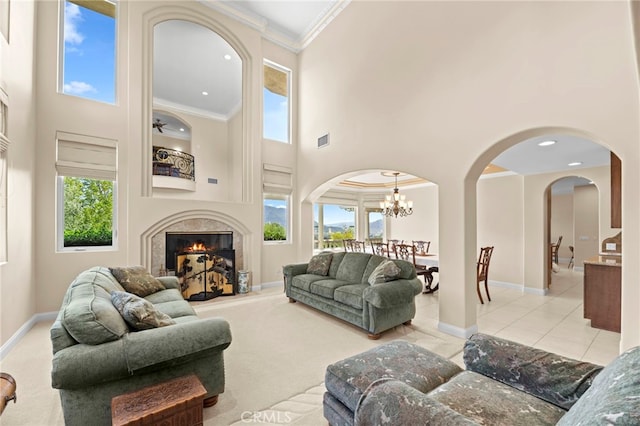 43845 Calle De Velardo, Temecula, CA 92592 - living area featuring a towering ceiling, arched walkways, a chandelier, crown molding, and healthy amount of natural light