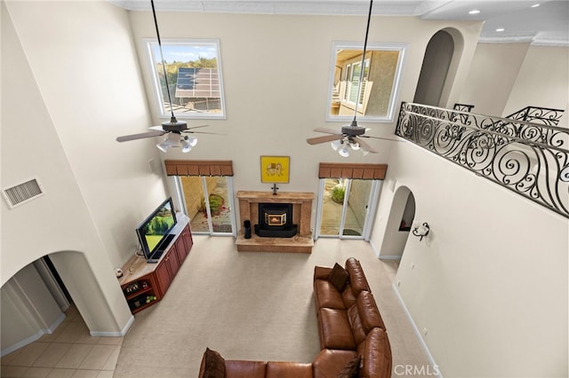 43845 Calle De Velardo, Temecula, CA 92592 - living room with ceiling fan, crown molding, a towering ceiling, a fireplace with raised hearth, and recessed lighting