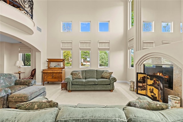 43845 Calle De Velardo, Temecula, CA 92592 - living area featuring carpet, a high ceiling, plenty of natural light, and a fireplace