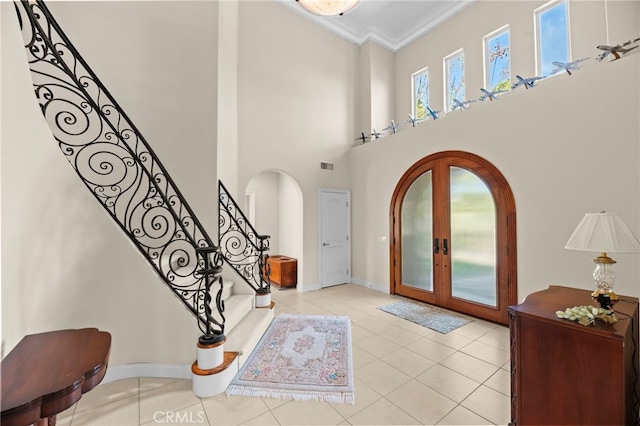 43845 Calle De Velardo, Temecula, CA 92592 - foyer featuring arched walkways, french doors, crown molding, light tile patterned floors, and stairs
