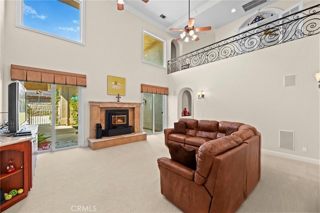 43845 Calle De Velardo, Temecula, CA 92592 - carpeted living room with ornamental molding, a high ceiling, a ceiling fan, and a high end fireplace