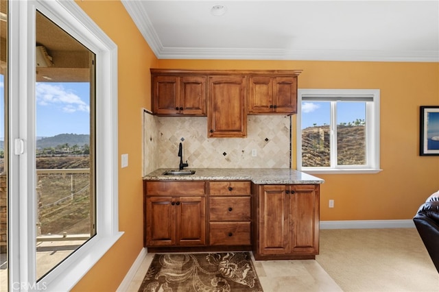 43845 Calle De Velardo, Temecula, CA 92592 - kitchen with light stone countertops, ornamental molding, brown cabinets, and backsplash
