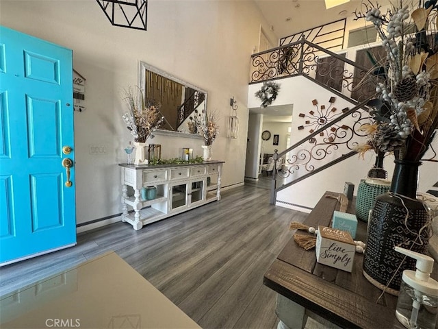 12477 Redrock Ct, Victorville, CA 92392 - entryway featuring wood finished floors, stairs, a high ceiling, and baseboards