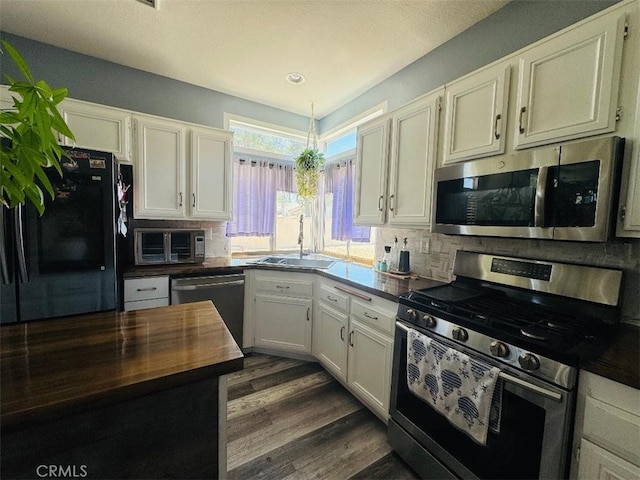12477 Redrock Ct, Victorville, CA 92392 - kitchen with appliances with stainless steel finishes, a sink, butcher block countertops, and tasteful backsplash
