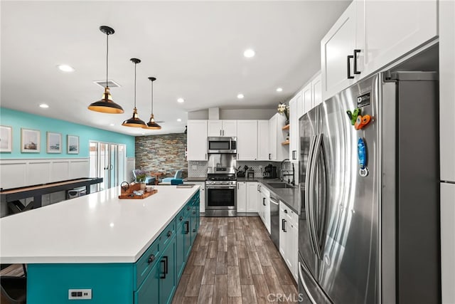 4941 Catamaran St, Oxnard, CA 93035 - kitchen featuring appliances with stainless steel finishes, a sink, white cabinetry, open shelves, and backsplash