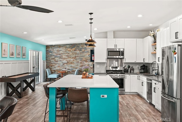 4941 Catamaran St, Oxnard, CA 93035 - kitchen with appliances with stainless steel finishes, a sink, light wood-style floors, open shelves, and recessed lighting