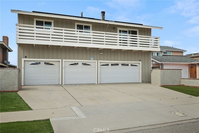 4941 Catamaran St, Oxnard, CA 93035 - view of front facade featuring a balcony, a garage, and concrete driveway