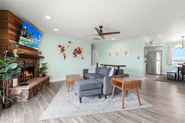 4941 Catamaran St, Oxnard, CA 93035 - living room with light wood-style flooring, a stone fireplace, baseboards, recessed lighting, and ceiling fan