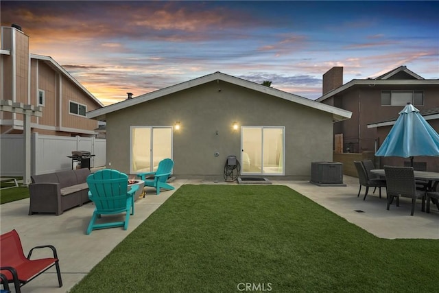 4941 Catamaran St, Oxnard, CA 93035 - back of house at dusk with a patio, central AC, stucco siding, and an outdoor hangout area