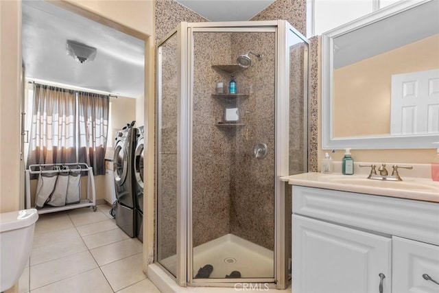 5741 Tobias Ave, Sherman Oaks, CA 91411 - full bath featuring washing machine and clothes dryer, a shower stall, vanity, tile patterned flooring, and toilet