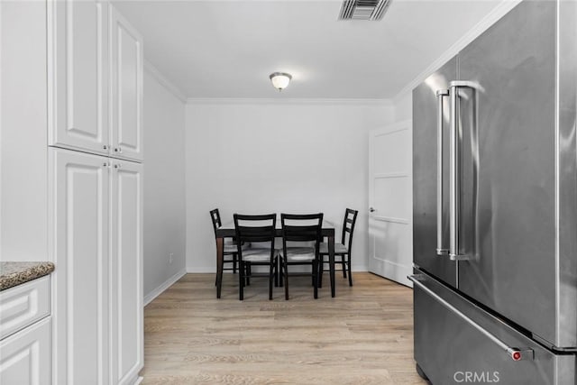 5741 Tobias Ave, Sherman Oaks, CA 91411 - dining area featuring light wood-style floors, ornamental molding, and baseboards