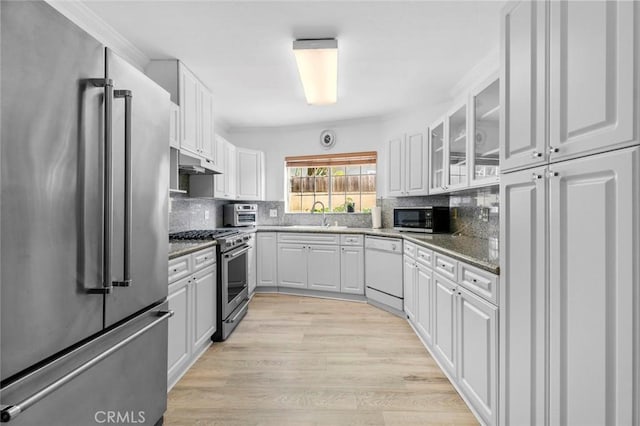 5741 Tobias Ave, Sherman Oaks, CA 91411 - kitchen with stainless steel appliances, white cabinets, and decorative backsplash