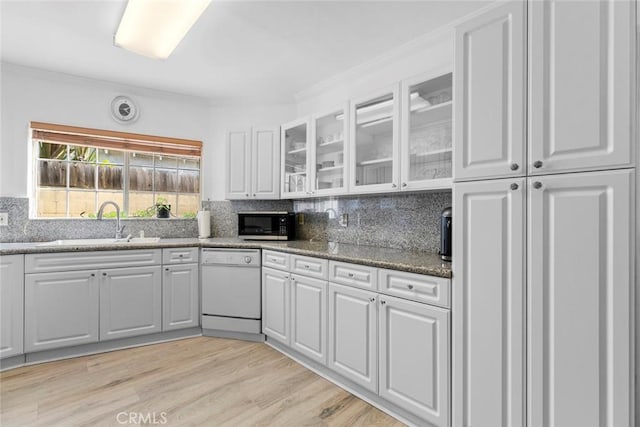 5741 Tobias Ave, Sherman Oaks, CA 91411 - kitchen featuring white dishwasher, black microwave, a sink, white cabinets, and crown molding