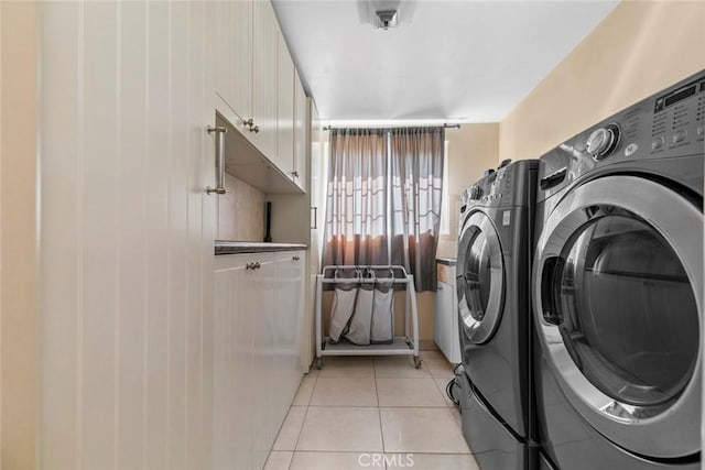 5741 Tobias Ave, Sherman Oaks, CA 91411 - laundry area with washing machine and clothes dryer, light tile patterned flooring, and cabinet space