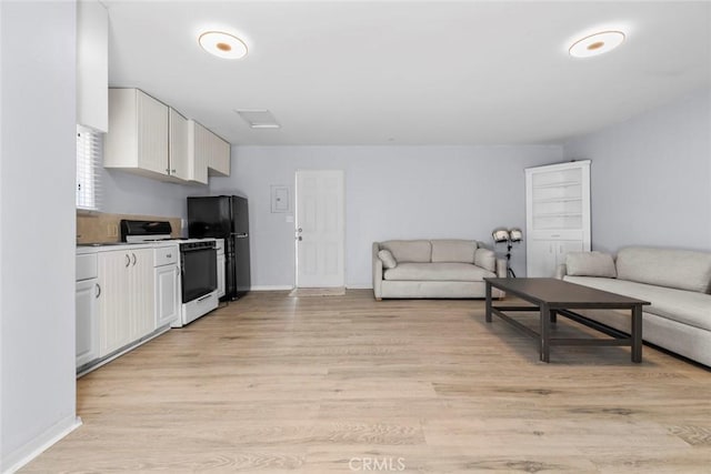 5741 Tobias Ave, Sherman Oaks, CA 91411 - living area featuring light wood-type flooring and baseboards