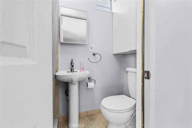 5741 Tobias Ave, Sherman Oaks, CA 91411 - bathroom featuring toilet, a sink, baseboards, and tile patterned floors