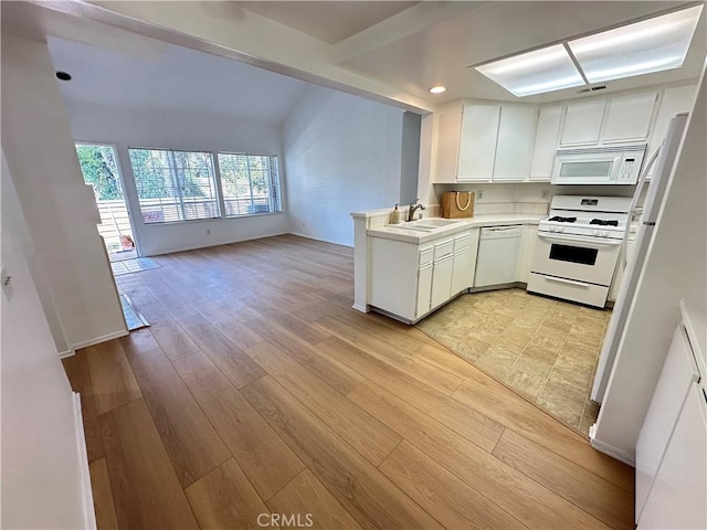 16521 Stonehaven Ct Unit 76, La Mirada, CA 90638 - kitchen with white appliances, a sink, light countertops, white cabinets, and light wood-style floors