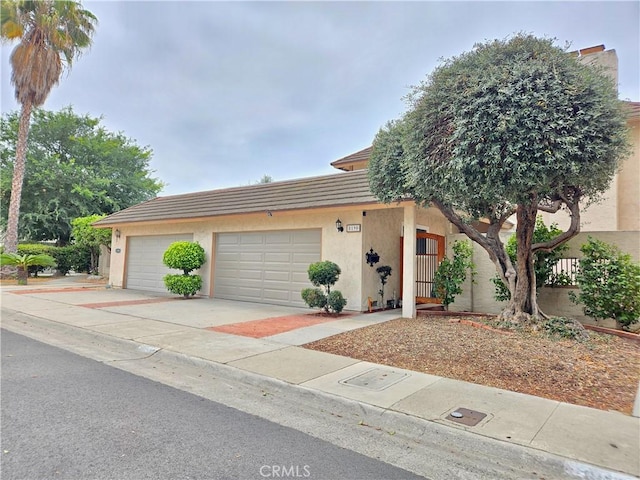 8190 Crowley Cir, Buena Park, CA 90621 - view of property featuring stucco siding, a garage, driveway, and a tiled roof