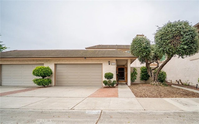 8190 Crowley Cir, Buena Park, CA 90621 - view of property featuring concrete driveway, stucco siding, and an attached garage