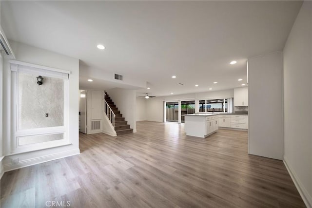 8190 Crowley Cir, Buena Park, CA 90621 - unfurnished living room with stairway, light wood-style floors, recessed lighting, and a ceiling fan