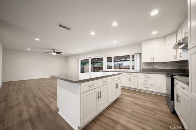 8190 Crowley Cir, Buena Park, CA 90621 - kitchen featuring electric range, under cabinet range hood, recessed lighting, a ceiling fan, and white cabinets
