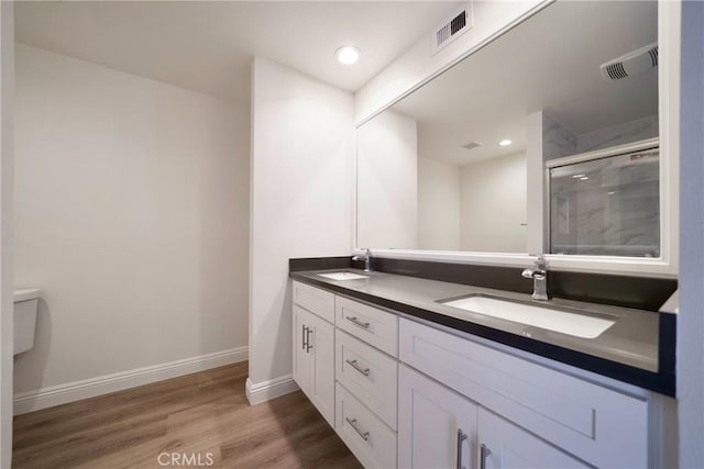 8190 Crowley Cir, Buena Park, CA 90621 - bathroom featuring double vanity, wood finished floors, a shower stall, and recessed lighting