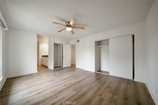 8190 Crowley Cir, Buena Park, CA 90621 - unfurnished bedroom with light wood-style floors, a closet, a ceiling fan, and connected bathroom