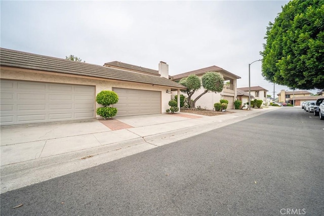8190 Crowley Cir, Buena Park, CA 90621 - view of property with a chimney, stucco siding, and a tiled roof